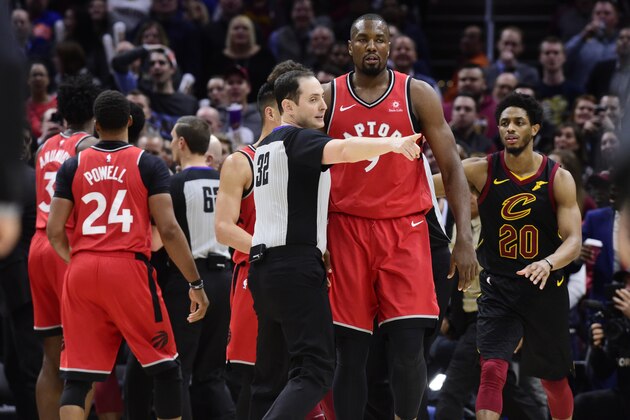 CLEVELAND, OHIO - MARCH 11: Referee Marat Kogut #32 directs Serge Ibaka #9 of the Toronto Raptors to the bench after he fought with Marquese Chriss #3 of the Cleveland Cavaliers during the second half at Quicken Loans Arena on March 11, 2019 in Cleveland, Ohio. The Cavaliers defeated the Raptors 126-101. NOTE TO USER: User expressly acknowledges and agrees that, by downloading and or using this photograph, User is consenting to the terms and conditions of the Getty Images License Agreement. (Photo by Jason Miller/Getty Images)