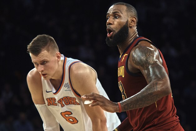 Cleveland Cavaliers' LeBron James, right, reacts next to New York Knicks' Kristaps Porzingis, left, during the second half of a NBA basketball game at Madison Square Garden in New York, Monday, Nov. 13, 2017. (AP Photo/Andres Kudacki)