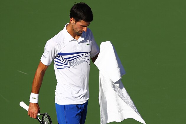 INDIAN WELLS, CALIFORNIA - MARCH 12: Novak Djokovic of Serbia walks to his chair after smashing his racket after losing the first set against Philipp Kohlschreiber of Germany during their men's singles third round match on day nine of the BNP Paribas Open at the Indian Wells Tennis Garden on March 12, 2019 in Indian Wells, California. (Photo by Clive Brunskill/Getty Images)
