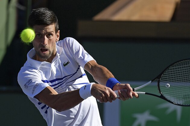Novak Djokovic, of Serbia, returns a shot to Philipp Kohlschreiber at the BNP Paribas Open tennis tournament Tuesday, March 12, 2019 in Indian Wells, Calif. (AP Photo/Mark J. Terrill)