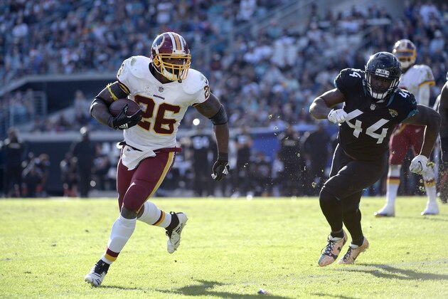 Washington Redskins running back Adrian Peterson (26) rushes for yardage in front of Jacksonville Jaguars middle linebacker Myles Jack (44) during the second half of an NFL football game Sunday, Dec. 16, 2018, in Jacksonville, Fla. (AP Photo/Phelan M. Ebenhack)