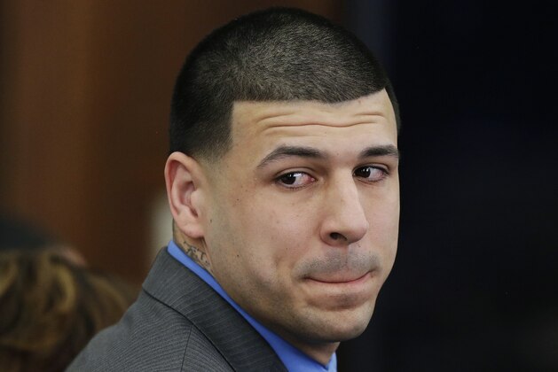FILE - In this Friday, April 14, 2017, file photo, former New England Patriots tight end Aaron Hernandez turns to look in the direction of the jury as he reacts to his double murder acquittal in the 2012 deaths of Daniel de Abreu and Safiro Furtado, at Suffolk Superior Court in Boston. Lawyers for the estate of Hernandez are trying to prevent a $20 million lawsuit against the National Football League from being merged with a wider class-action suit addressing former NFL players’ head injuries. (AP Photo/Stephan Savoia, Pool, File)