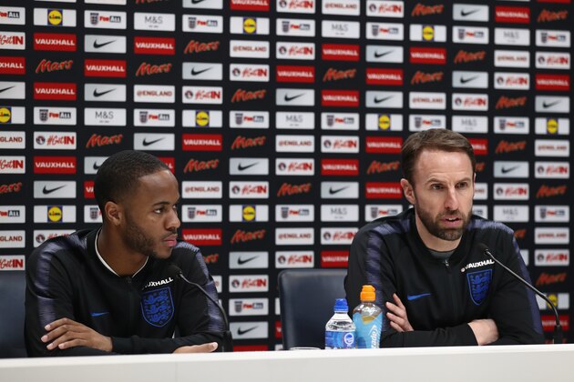 ENFIELD, ENGLAND - MARCH 26:  Gareth Southgate manager of England speaks as Raheem Sterling looks on during an England press conference on the eve of their international friendly against Italy at Tottenham Hotspur Training Centre, on March 26, 2018 in Enfield, England.  (Photo by Catherine Ivill/Getty Images)
