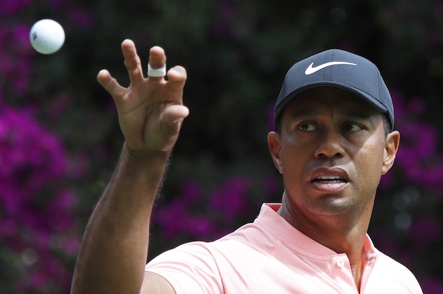 Tiger Woods prepares to catch a ball thrown by his caddy on the second day of competition of the WGC-Mexico Championship at the Chapultepec Golf Club in Mexico City, Friday, Feb. 22, 2019. (AP Photo/Marco Ugarte)