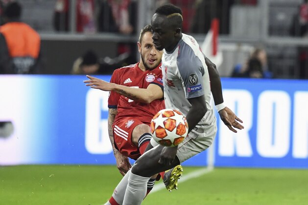 Bayern defender Rafinha, left, duels for the ball with Liverpool midfielder Sadio Mane during the Champions League round of 16 second leg soccer match between Bayern Munich and Liverpool at the Allianz Arena, in Munich, Germany, Wednesday, March 13, 2019. (AP Photo/Kerstin Joensson)