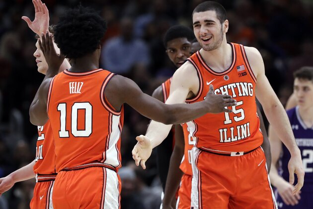 Illinois forward Giorgi Bezhanishvili, right, smiles as he celebrates with guard Andres Feliz after scoring a basket against Northwestern during the first half of an NCAA college basketball game in the first round of the Big Ten Conference tournament in Chicago, Wednesday, March 13, 2019. (AP Photo/Nam Y. Huh)