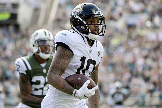 Jacksonville Jaguars wide receiver Donte Moncrief (10) runs for a 67-yard touchdown on a pass play in front of New York Jets cornerback Trumaine Johnson (22) during the second half of an NFL football game, Sunday, Sept. 30, 2018, in Jacksonville, Fla. (AP Photo/Phelan M. Ebenhack)