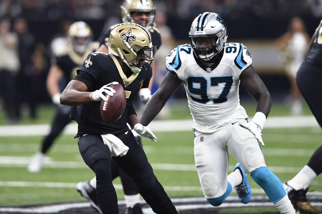 New Orleans Saints quarterback Teddy Bridgewater (5) scrambles under pressure from Carolina Panthers defensive end Mario Addison (97) in the first half of an NFL football game in New Orleans, Sunday, Dec. 30, 2018. (AP Photo/Bill Feig)