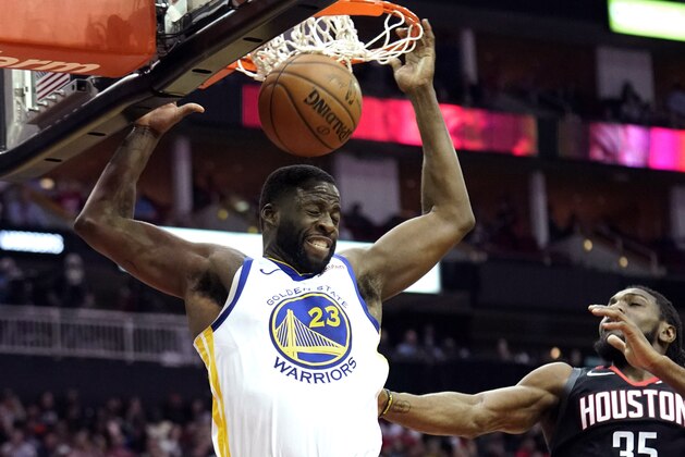 Golden State Warriors' Draymond Green (23) dunks the ball as Houston Rockets' Kenneth Faried (35) defends during the first half of an NBA basketball game, Wednesday, March 13, 2019, in Houston. (AP Photo/David J. Phillip)