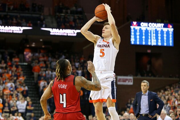 CHARLOTTESVILLE, VA - MARCH 09: Kyle Guy #5 of the Virginia Cavaliers shoots over Khwan Fore #4 of the Louisville Cardinals in the second half during a game at John Paul Jones Arena on March 9, 2019 in Charlottesville, Virginia. (Photo by Ryan M. Kelly/Getty Images)