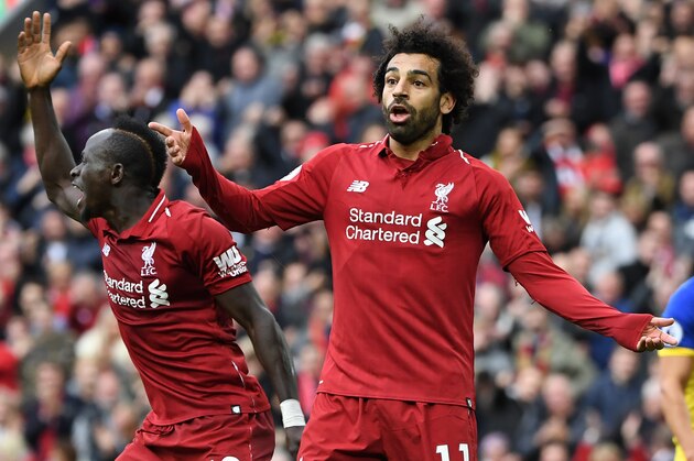 Liverpool's Senegalese striker Sadio Mane (L) and Liverpool's Egyptian midfielder Mohamed Salah gesture during the English Premier League football match between Liverpool and Southampton at Anfield in Liverpool, north west England on September 22, 2018. (Photo by Paul ELLIS / AFP) / RESTRICTED TO EDITORIAL USE. No use with unauthorized audio, video, data, fixture lists, club/league logos or 'live' services. Online in-match use limited to 120 images. An additional 40 images may be used in extra time. No video emulation. Social media in-match use limited to 120 images. An additional 40 images may be used in extra time. No use in betting publications, games or single club/league/player publications. /         (Photo credit should read PAUL ELLIS/AFP/Getty Images)