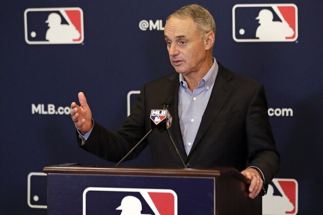 File-This Feb. 8, 2019, file photo shows Rob Manfred, commissioner of Major League Baseball, speaking during a news conference at owners meetings in Orlando, Fla. Major League Baseball and the players' union are near an agreement to expand active rosters by one to 26 starting in 2020 as part of a deal that would include a commitment to discuss larger economic issues after opening day.  (AP Photo/John Raoux, File)