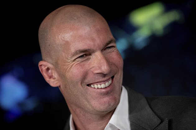 Newly appointed Real Madrid head coach Zinedine Zidane smiles, during a press conference in Madrid, Monday March 11, 2019. Real Madrid picked one of its most successful coaches to try to end one of its worst crises.  Zinedine Zidane is returning to coach Real Madrid, the club he led to three straight Champions League titles. (AP Photo/Bernat Armangue)