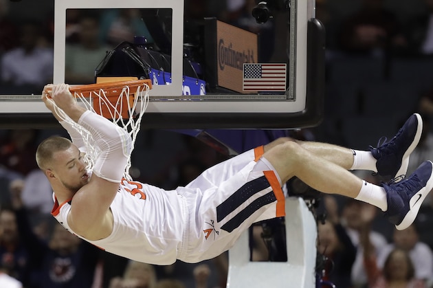 Virginia's Jack Salt (33) hangs from the rim after a dunk against North Carolina State during the second half of an NCAA college basketball game in the Atlantic Coast Conference tournament in Charlotte, N.C., Thursday, March 14, 2019. Salt was called for a technical foul on the play. (AP Photo/Chuck Burton)