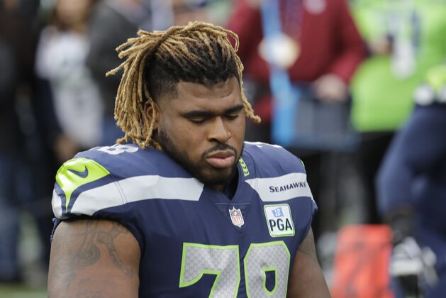 Seattle Seahawks offensive guard D.J. Fluker stretches before an NFL football game against the San Francisco 49ers, Sunday, Dec. 2, 2018, in Seattle. (AP Photo/Elaine Thompson) Seattle Seahawks offensive guard D.J. Fluker stretches before an NFL football game against the San Francisco 49ers, Sunday, Dec. 2, 2018, in Seattle. (AP Photo/Elaine Thompson)