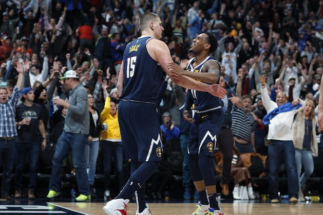 Denver Nuggets center Nikola Jokic, left, is congratulated for his game-winning basket by guard Monte Morris during the team's NBA basketball game against the Dallas Mavericks on Thursday, March 14, 2019, in Denver. The Nuggets won 100-99. (AP Photo/David Zalubowski)