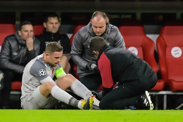 Liverpool's English midfielder Jordan Henderson recieves medical attention during the UEFA Champions League, last 16, second leg football match Bayern Munich v Liverpool in Munich, southern Germany, on March 13, 2019. (Photo by GUENTER SCHIFFMANN / AFP)        (Photo credit should read GUENTER SCHIFFMANN/AFP/Getty Images)
