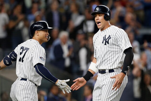 NEW YORK, NY - OCTOBER 03:  (NEW YORK DAILIES OUT)   Aaron Judge #99 and Giancarlo Stanton #27 of the New York Yankees during the sixth inning against the Oakland Athletics in the American League Wild Card Game at Yankee Stadium on October 3, 2018 in the Bronx borough of New York City. The Yankees defeated the Athletics 7-2.  (Photo by Jim McIsaac/Getty Images)