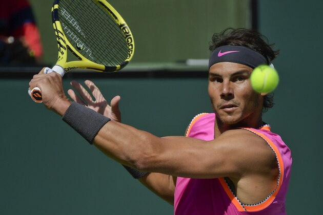 Rafael Nadal, of Spain, keeps his eyes on the ball as he hits a return to Karen Khachanov, of Russia, at the BNP Paribas Open tennis tournament Friday, March 15, 2019, in Indian Wells, Calif. (AP Photo/Mark J. Terrill)