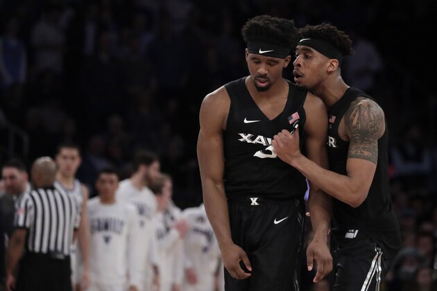 Xavier guard Paul Scruggs, right, consoles teammate guard Quentin Goodin after a play against Villanova during overtime of an NCAA college basketball semifinal game in the Big East men's tournament, Friday, March 15, 2019, in New York. Villanova won 71-67 in overtime. (AP Photo/Julio Cortez)
