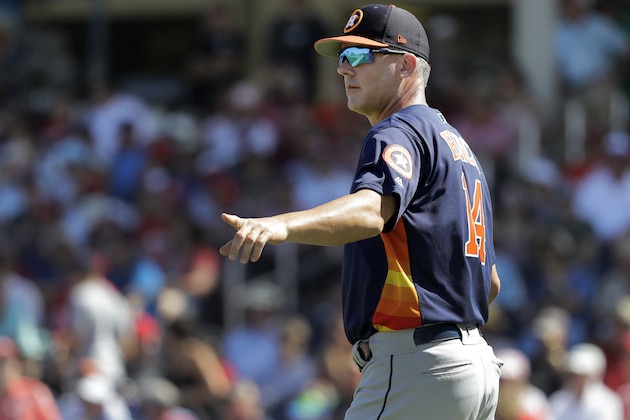 Houston Astros manager AJ Hinch motions to the bullpen as he walks out to the mound to make pitching change during the third inning of an exhibition spring training baseball game against the Washington Nationals Sunday, March 3, 2019, in West Palm Beach, Fla. (AP Photo/Jeff Roberson)