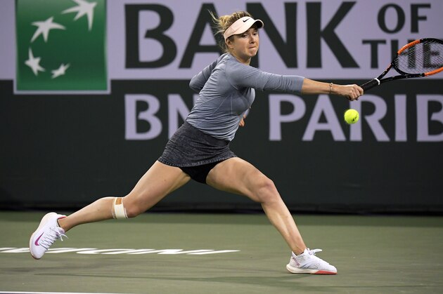 Elina Svitolina, of Ukraine, reaches for a shot form Bianca Andreescu, of Canada, at the BNP Paribas Open tennis tournament Friday, March 15, 2019, in Indian Wells, Calif. (AP Photo/Mark J. Terrill)