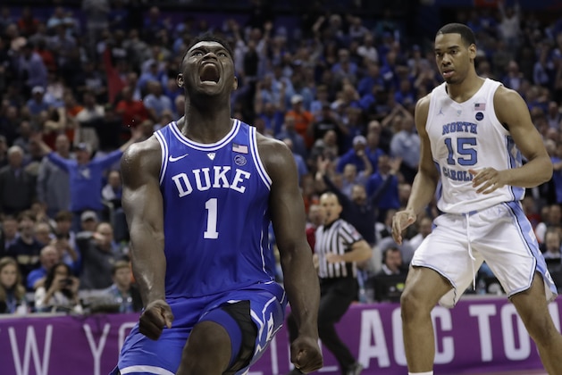Duke's Zion Williamson (1) reacts after a dunk as North Carolina's Garrison Brooks (15) looks on during the second half of an NCAA college basketball game in the Atlantic Coast Conference tournament in Charlotte, N.C., Friday, March 15, 2019. (AP Photo/Nell Redmond)