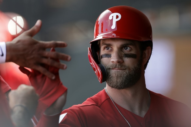 Philadelphia Phillies' Bryce Harper high-fives teammates after being taken out during the third inning of a spring training baseball game against the Toronto Blue Jays, Saturday, March 9, 2019, in Clearwater, Fla. (AP Photo/Chris O'Meara)