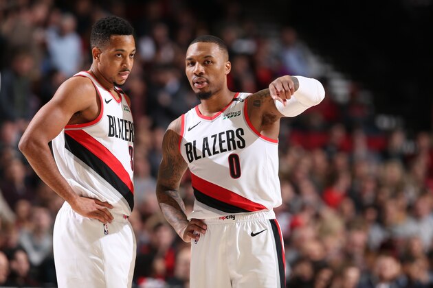 PORTLAND, OR - DECEMBER 19:  CJ McCollum #3 and Damian Lillard #0 of the Portland Trail Blazers look on against the Memphis Grizzlies on December 19, 2018 at the Moda Center Arena in Portland, Oregon. NOTE TO USER: User expressly acknowledges and agrees that, by downloading and or using this photograph, user is consenting to the terms and conditions of the Getty Images License Agreement. Mandatory Copyright Notice: Copyright 2018 NBAE (Photo by Sam Forencich/NBAE via Getty Images)