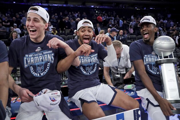 Villanova's Collin Gillespie, left, Phil Booth, and Dhamir Cosby-Roundtree celebrate after defeating Seton Hall 74-72 in an NCAA college basketball game in the championship of the Big East Conference tournament, Saturday, March 16, 2019, in New York. (AP Photo/Julio Cortez)