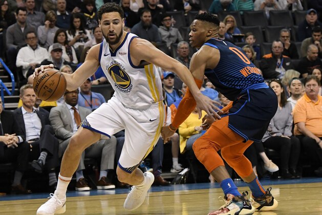 Oklahoma City Thunder guard Russell Westbrook (0) defends against Golden State Warriors guard Klay Thompson (11) during the first half of an NBA basketball game Saturday, March 16, 2019, in Oklahoma City. (AP Photo/June Frantz Hunt)