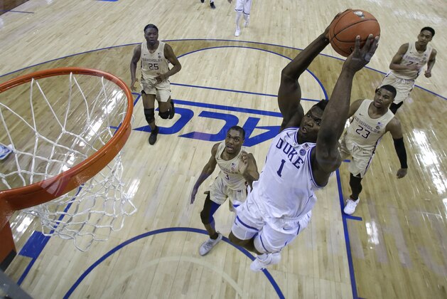 Duke's Zion Williamson (1) goes up to dunk against Florida State during the first half of the NCAA college basketball championship game of the Atlantic Coast Conference tournament in Charlotte, N.C., Saturday, March 16, 2019. (AP Photo/Chuck Burton)