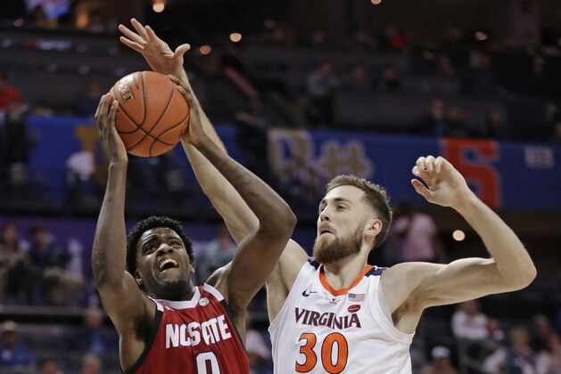 North Carolina State's DJ Funderburk (0) shoots against Virginia's Jay Huff (30) during the first half of an NCAA college basketball game in the Atlantic Coast Conference tournament in Charlotte, N.C., Thursday, March 14, 2019. (AP Photo/Nell Redmond)
