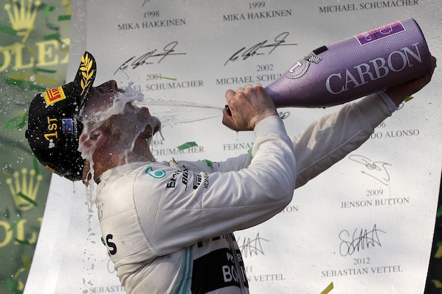 Mercedes driver Valtteri Bottas of Finland sprays himself with champagne after winning the Australian Formula 1 Grand Prix in Melbourne, Australia, Sunday, March 17, 2019. Bottas won ahead of teammate Lewis Hamilton of Britain while Red Bull driver Max Verstappen of the Netherlands placed third.(AP Photo/Rick Rycroft)
