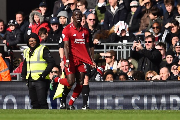Liverpool's Senegalese striker Sadio Mane celebrates scoring the team's first goal during the English Premier League football match between Fulham and Liverpool at Craven Cottage in London on March 17, 2019. (Photo by Glyn KIRK / AFP) / RESTRICTED TO EDITORIAL USE. No use with unauthorized audio, video, data, fixture lists, club/league logos or 'live' services. Online in-match use limited to 120 images. An additional 40 images may be used in extra time. No video emulation. Social media in-match use limited to 120 images. An additional 40 images may be used in extra time. No use in betting publications, games or single club/league/player publications. /         (Photo credit should read GLYN KIRK/AFP/Getty Images)