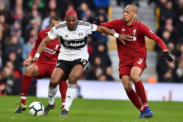 Fulham's Dutch defender Ryan Babel (L) vies with Liverpool's Brazilian midfielder Fabinho during the English Premier League football match between Fulham and Liverpool at Craven Cottage in London on March 17, 2019. (Photo by Glyn KIRK / AFP) / RESTRICTED TO EDITORIAL USE. No use with unauthorized audio, video, data, fixture lists, club/league logos or 'live' services. Online in-match use limited to 120 images. An additional 40 images may be used in extra time. No video emulation. Social media in-match use limited to 120 images. An additional 40 images may be used in extra time. No use in betting publications, games or single club/league/player publications. /         (Photo credit should read GLYN KIRK/AFP/Getty Images)