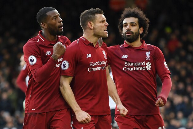 LONDON, ENGLAND - MARCH 17:  James Milner of Liverpool celebrates with his teammates after he scores his sides second goal from the penalty spot  during the Premier League match between Fulham FC and Liverpool FC at Craven Cottage on March 17, 2019 in London, United Kingdom. (Photo by Michael Regan/Getty Images)