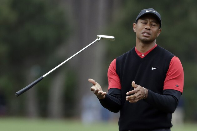 Tiger Woods flips his club after his shot to the 10th green during the final round of The Players Championship golf tournament Sunday, March 17, 2019, in Ponte Vedra Beach, Fla. (AP Photo/Lynne Sladky)