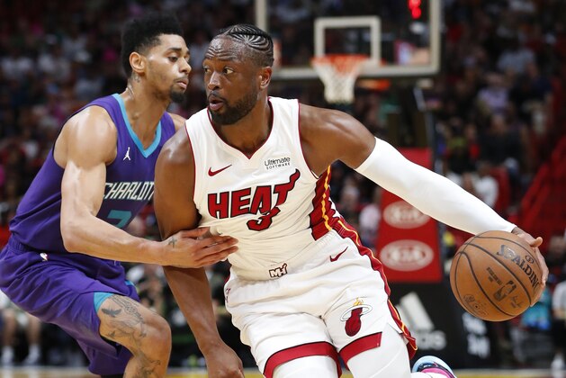 Miami Heat guard Dwyane Wade, right, drives past Charlotte Hornets guard Jeremy Lamb during the second half of an NBA basketball game, Sunday, March 17, 2019, in Miami. (AP Photo/Wilfredo Lee)