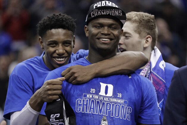 Duke's RJ Barrett, left, hugs Zion Williamson after Duke defeated Florida State in the NCAA college basketball championship game of the Atlantic Coast Conference tournament in Charlotte, N.C., Saturday, March 16, 2019. (AP Photo/Chuck Burton)