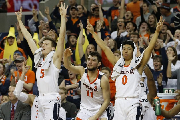 Virginia guards Kyle Guy (5), Ty Jerome (11) and Kihei Clark (0) celebrates a teammates 3-point basket during the second half of an NCAA college basketball game in Charlottesville, Va., Saturday, March 2, 2019. Virginia defeated Pittsburgh 73-49. (AP Photo/Steve Helber)