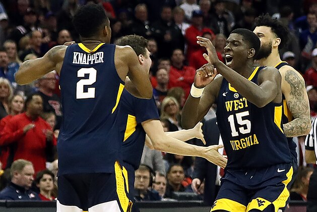 KANSAS CITY, MISSOURI - MARCH 14:  Lamont West #15 of the West Virginia Mountaineers celebrates with teammates after the Mountaineers defeated the Texas Tech Red Raiders to win their quarterfinal game of the Big 12 Basketball Tournament at Sprint Center on March 14, 2019 in Kansas City, Missouri. (Photo by Jamie Squire/Getty Images)