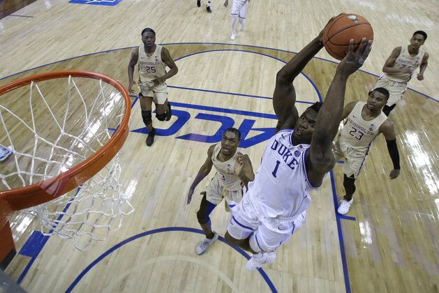 Duke's Zion Williamson (1) goes up to dunk against Florida State during the first half of the NCAA college basketball championship game of the Atlantic Coast Conference tournament in Charlotte, N.C., Saturday, March 16, 2019. (AP Photo/Chuck Burton)