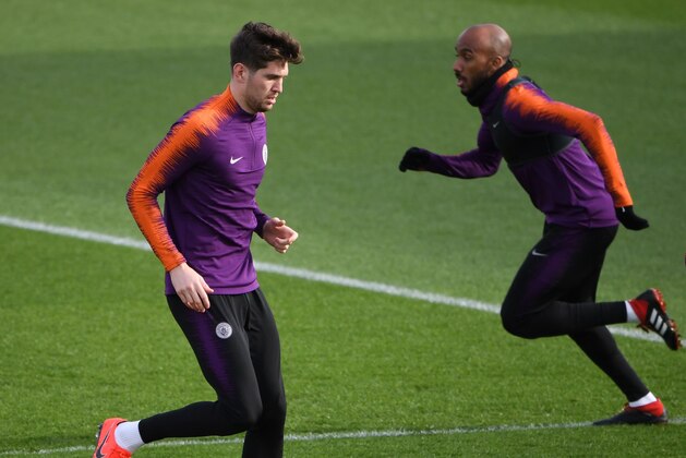 Manchester City's English defender John Stones (L) and Manchester City's English midfielder Fabian Delph attend a team training session at City Football Academy in Manchester, north west England on March 11, 2019 on the eve of their Champions League round of 16, second leg football match against FC Schalke. (Photo by Paul ELLIS / AFP)        (Photo credit should read PAUL ELLIS/AFP/Getty Images)