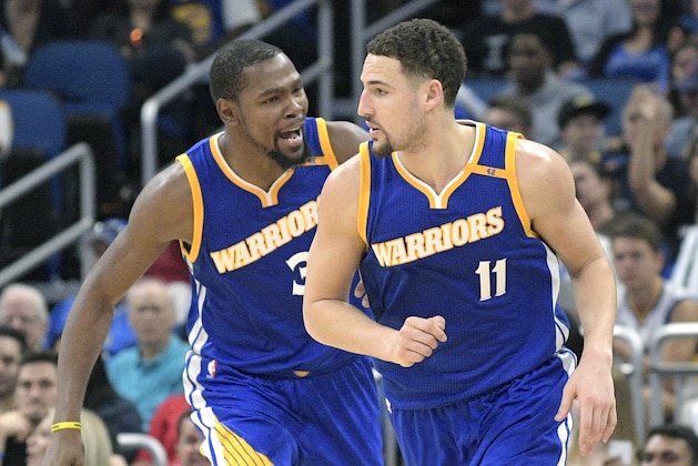 Golden State Warriors guard Klay Thompson (11) is congratulated by forward Kevin Durant, left, after making a three-point basket during the second half of an NBA basketball game against the Orlando Magic in Orlando, Fla., Sunday, Jan. 22, 2017. (AP Photo/Phelan M. Ebenhack)