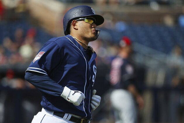 San Diego Padres' Manny Machado runs down to first base after hitting a pop fly against the Cleveland Indians during the first inning of a spring training baseball game Monday, March 4, 2019, in Peoria, Ariz. (AP Photo/Ross D. Franklin)