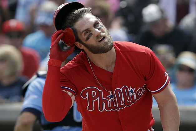 Philadelphia Phillies' Bryce Harper takes off his helmet after striking out against Tampa Bay Rays starting pitcher Blake Snell during the first inning of a spring training baseball game Monday, March 11, 2019, in Clearwater, Fla. (AP Photo/Chris O'Meara)