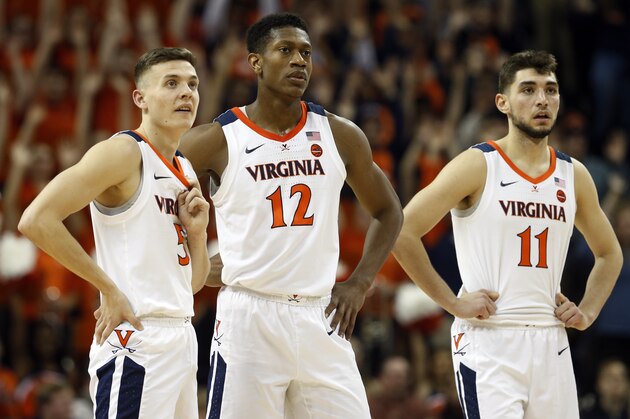 Virginia guard Kyle Guy (5) Virginia guard De'Andre Hunter (12) and Virginia guard Ty Jerome (11) watch a foul shot during the second half of an NCAA college basketball game in Charlottesville, Va., Tuesday, Jan. 22, 2019. Virginia defeated Wake Forest 68-45. (AP Photo/Steve Helber)