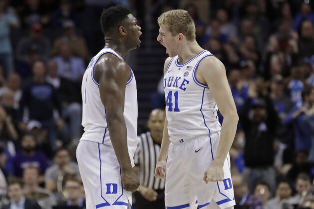 Duke's Zion Williamson, left, celebrates with Jack White, right, after a play against Florida State during the second half of the NCAA college basketball championship game of the Atlantic Coast Conference tournament in Charlotte, N.C., Saturday, March 16, 2019. (AP Photo/Nell Redmond)