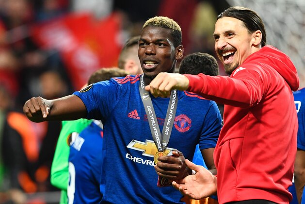 Manchester United's French midfielder Paul Pogba celebrates with his medal and Manchester United's Swedish striker Zlatan Ibrahimovic (R) after the UEFA Europa League final football match Ajax Amsterdam v Manchester United on May 24, 2017 at the Friends Arena in Solna outside Stockholm. / AFP PHOTO / Jonathan NACKSTRAND        (Photo credit should read JONATHAN NACKSTRAND/AFP/Getty Images)